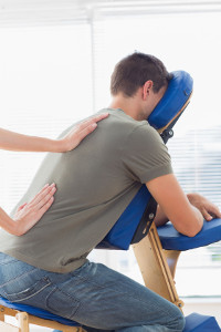 27112182-cropped-image-of-therapist-giving-back-massage-to-man-on-massage-chair-in-hospital